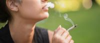 woman smoking a marijuana cigarette